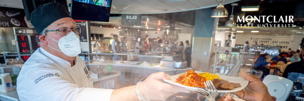 Chef serving a plate of food 